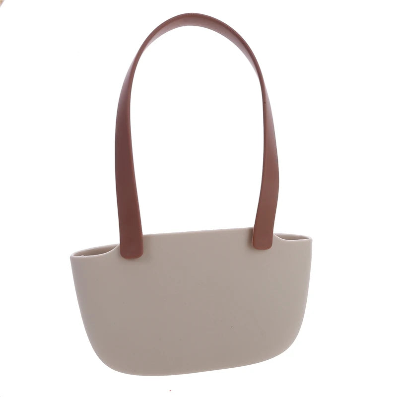 Beige handbag with brown handles on a white background