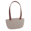 Beige handbag with brown handles on a white background