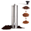 Manual coffee grinder with coffee beans and grounds on a white background