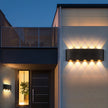 Modern building exterior with illuminated wall lights at night