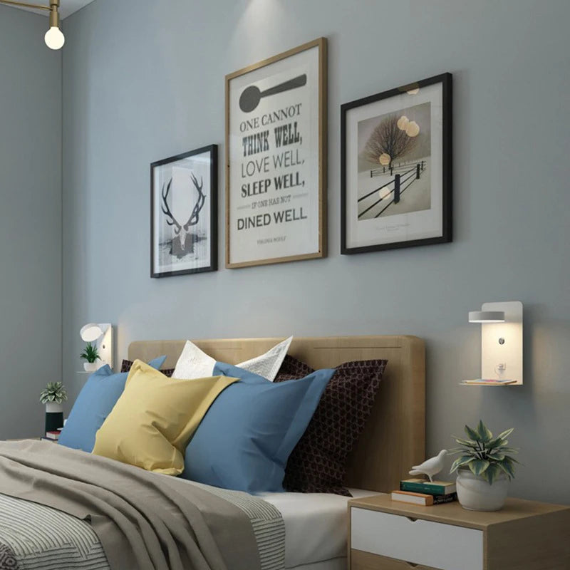 Bedroom with a bed featuring colorful pillows, framed artwork on the wall, and nightstands with lamps.