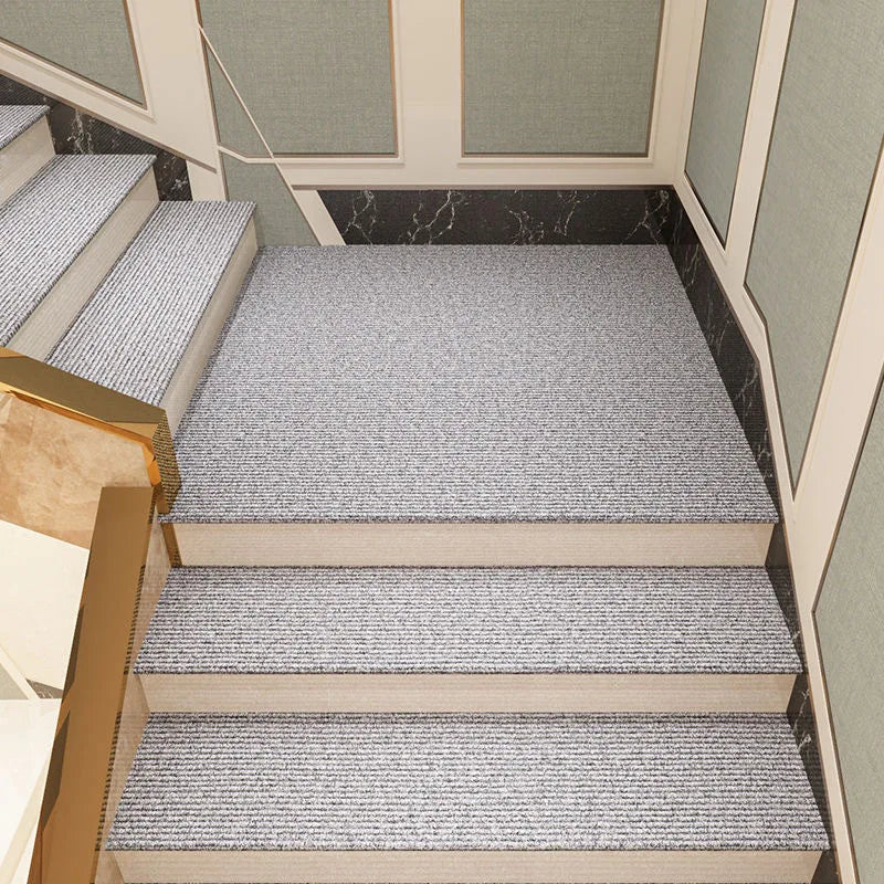 Staircase with textured gray carpet on each step