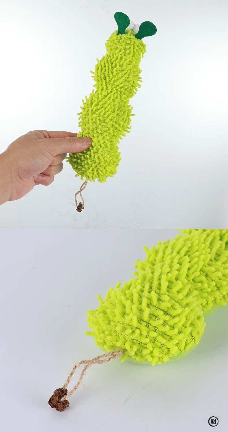 Hand holding a green caterpillar-shaped toy with a plain white background