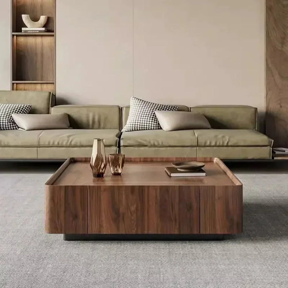 Modern living room with a green sofa and wooden coffee table.