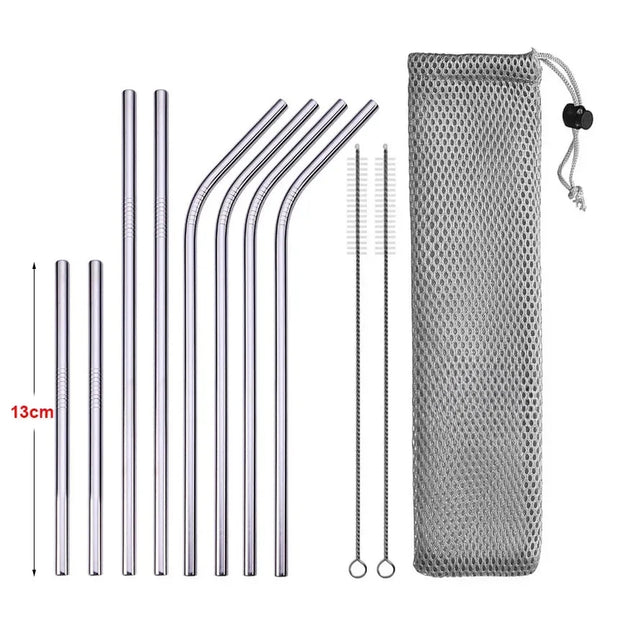 Set of metal straws with cleaning brush and mesh pouch on a white background
