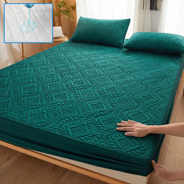 Green quilted mattress cover on a bed with a close-up inset showing water resistance.