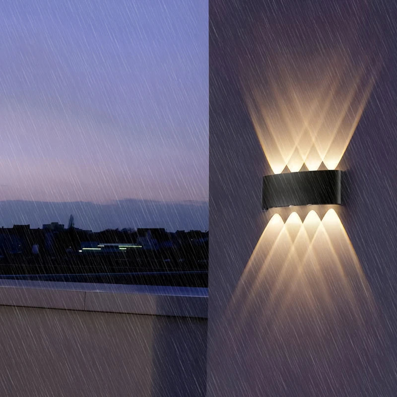 Outdoor wall light fixture on a rainy evening with cityscape in the background