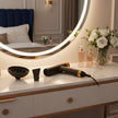 Black hair dryer with gold accents and attachments on a white background
