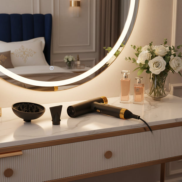Black hair dryer with gold accents and attachments on a white background