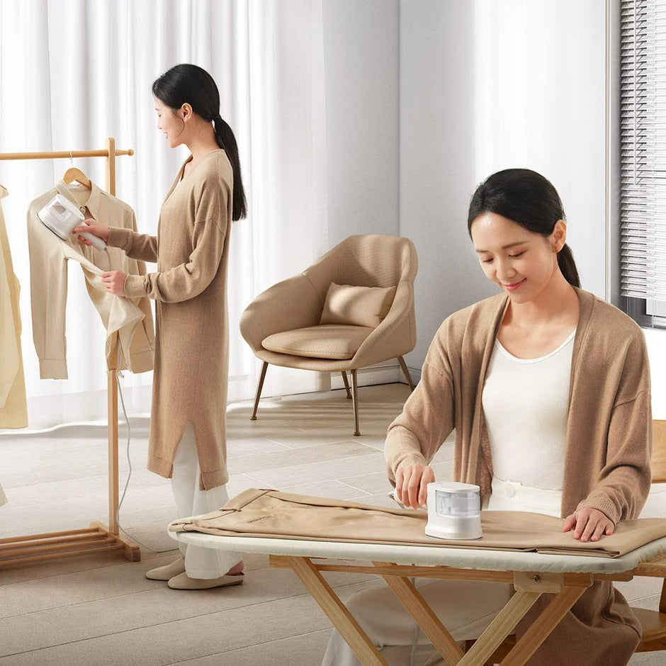 Woman ironing clothes in a bright room with minimal decor