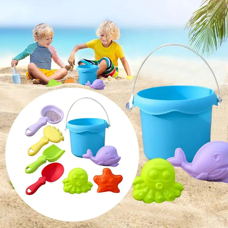 Children playing with beach toys including a blue bucket and various tools on a sandy beach.