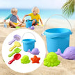 Children playing with beach toys including a blue bucket and various tools on a sandy beach.
