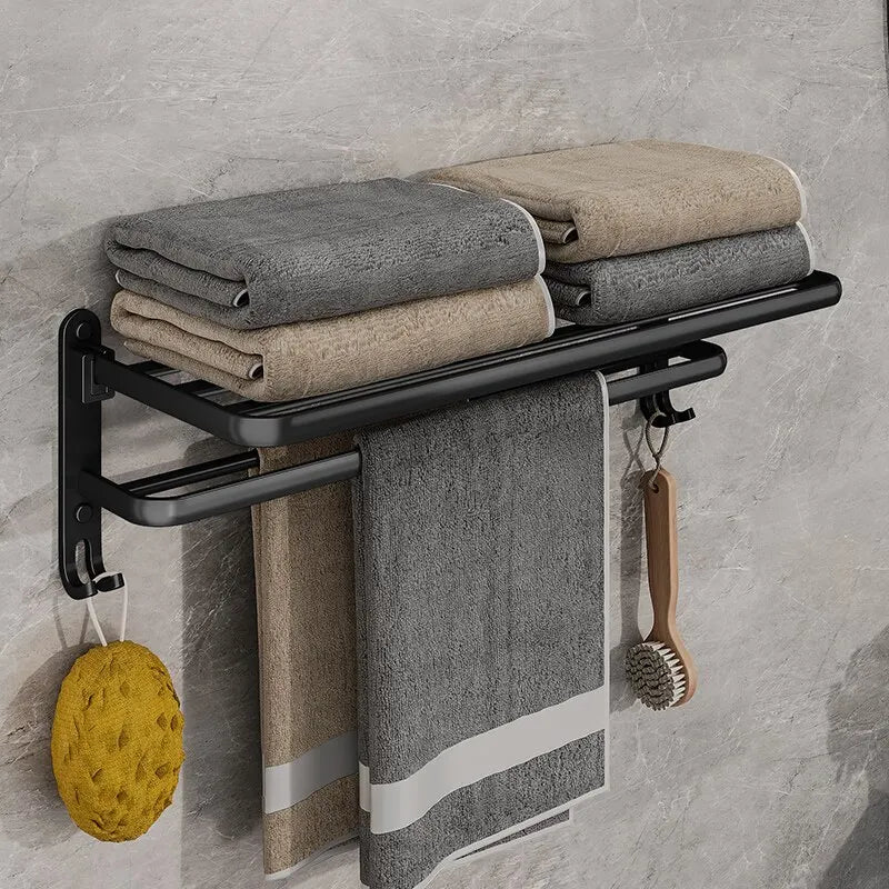 Towel rack with folded towels and cleaning tools against a gray tiled wall.