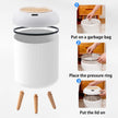 White trash bin with assembly instructions on a white background