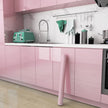 Modern kitchen with pink cabinets and green appliances