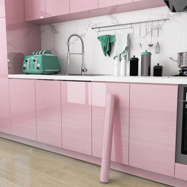 Modern kitchen with pink cabinets and green appliances