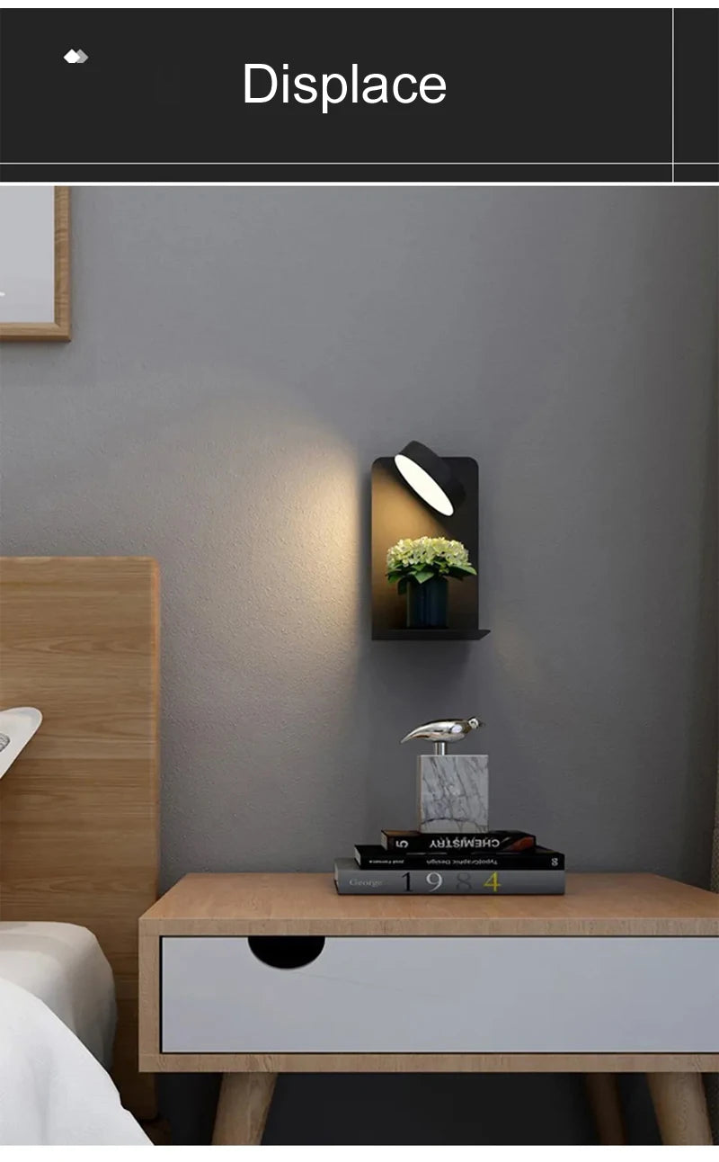 Modern bedroom setup with wooden nightstand, books, and decorative items against a gray wall.