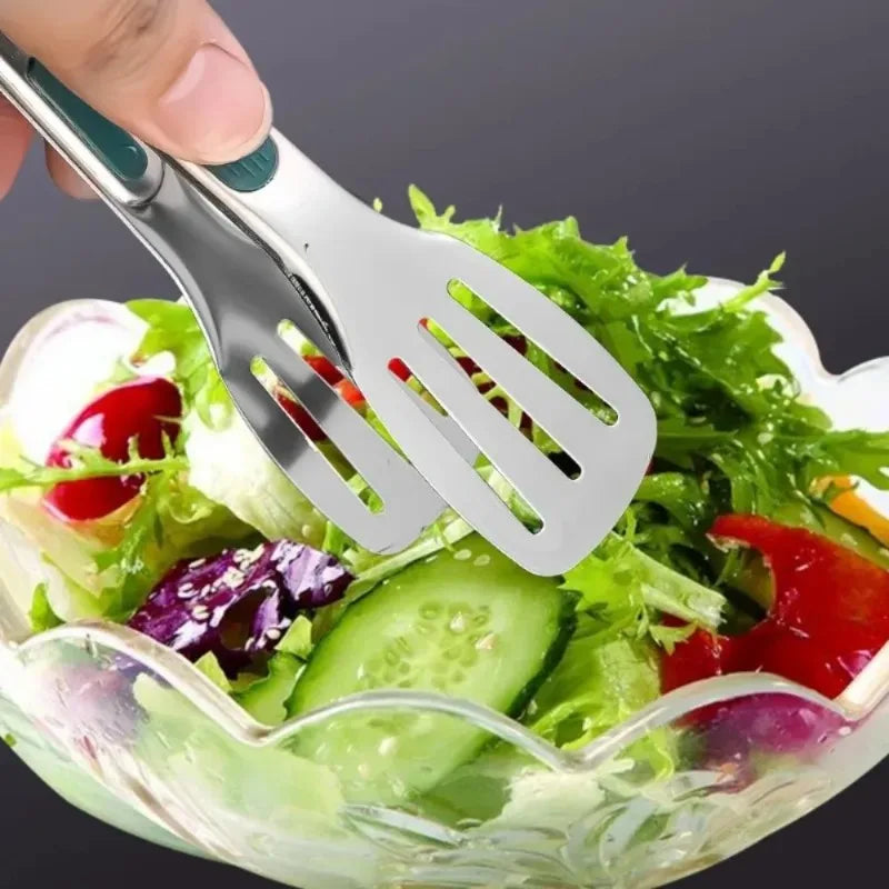 Salad server being used on a salad with a clear bowl