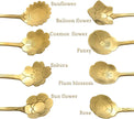 Gold floral spoons with engraved designs on a white background