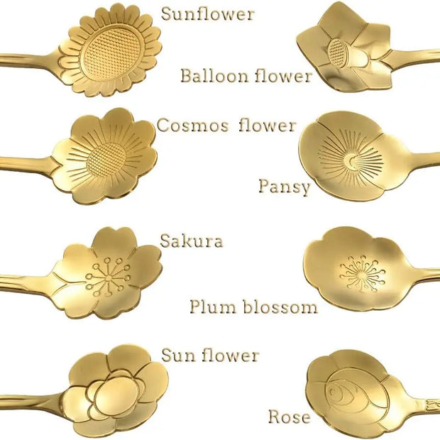 Gold floral spoons with engraved designs on a white background
