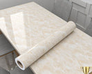 Roll of beige marble-patterned vinyl flooring on a table.