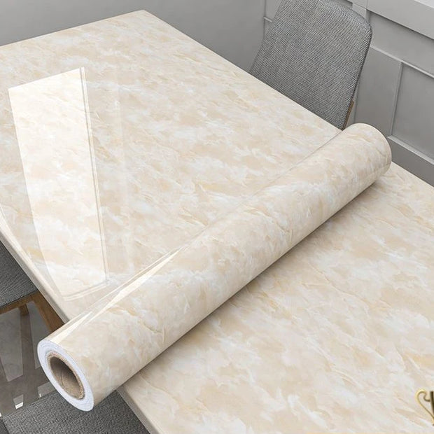 Roll of beige marble-patterned vinyl flooring on a table.