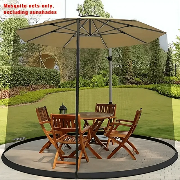 Beige patio umbrella with mosquito net over a wooden outdoor table and chairs on a grassy area.