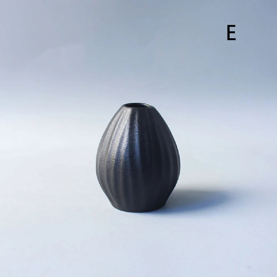 Black textured vase on a light gray background