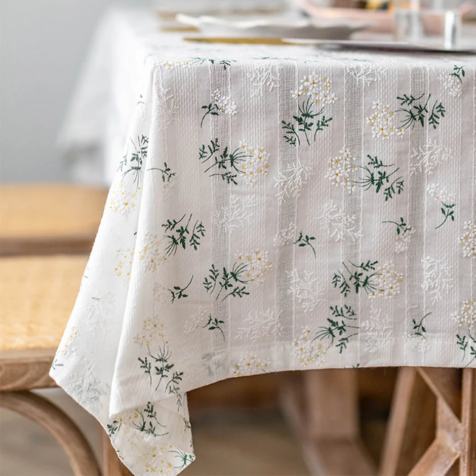 Floral patterned tablecloth on a wooden table with a blurred background