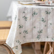 Floral patterned tablecloth on a wooden table with a blurred background