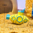 Yellow toy submarine with measurements on a sandy surface