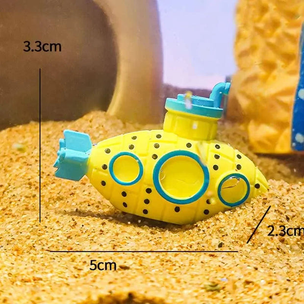Yellow toy submarine with measurements on a sandy surface