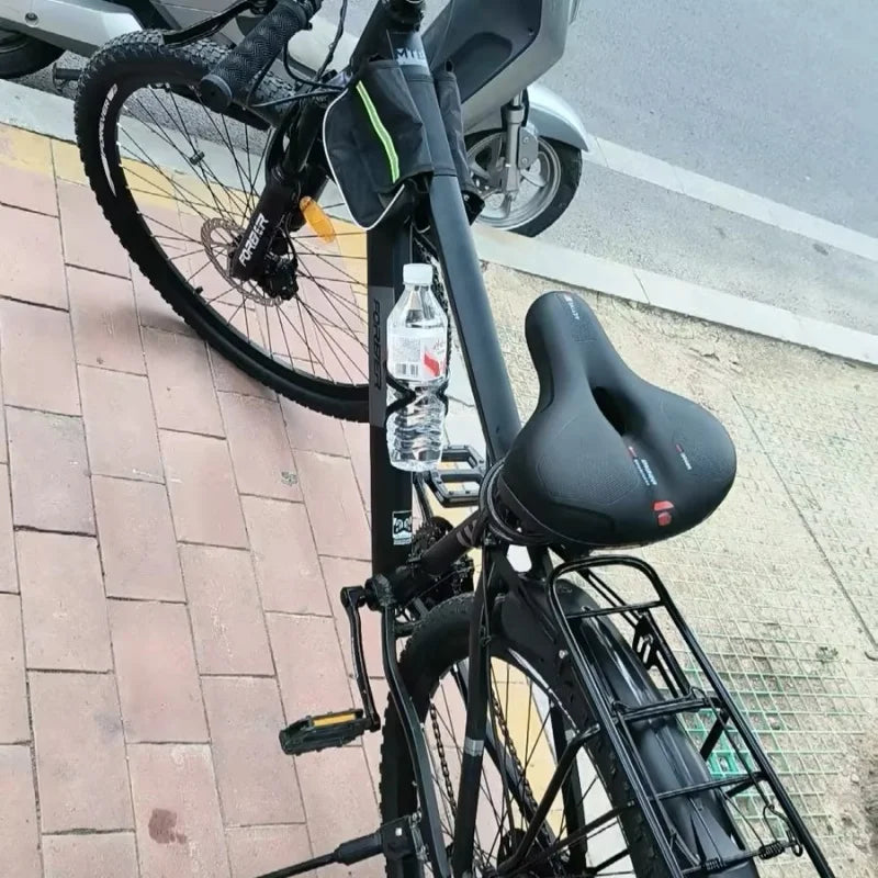 Black bicycle with a water bottle on a sidewalk