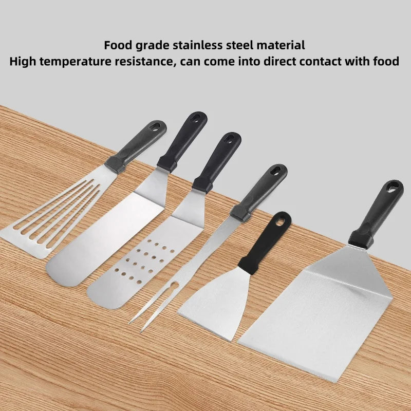 Set of stainless steel spatulas on a wooden surface with text about food-grade material and high temperature resistance.