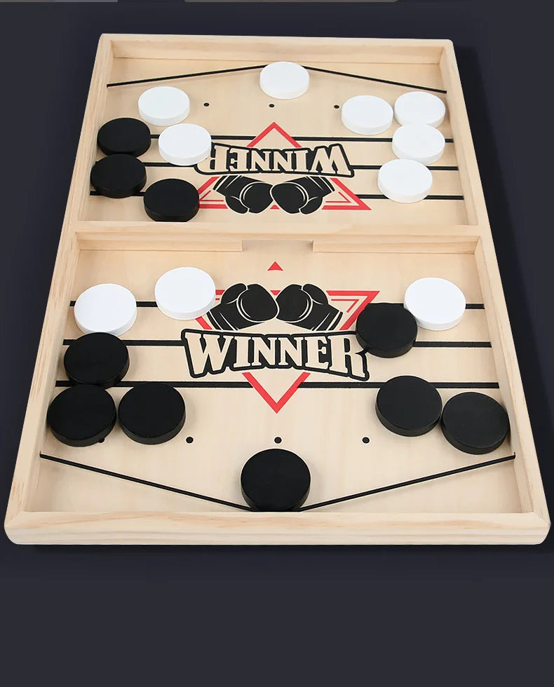 Wooden game board with hockey pucks and 'Winner' text on a dark background