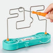 Teal toy with metal frame and orange handle on a white background