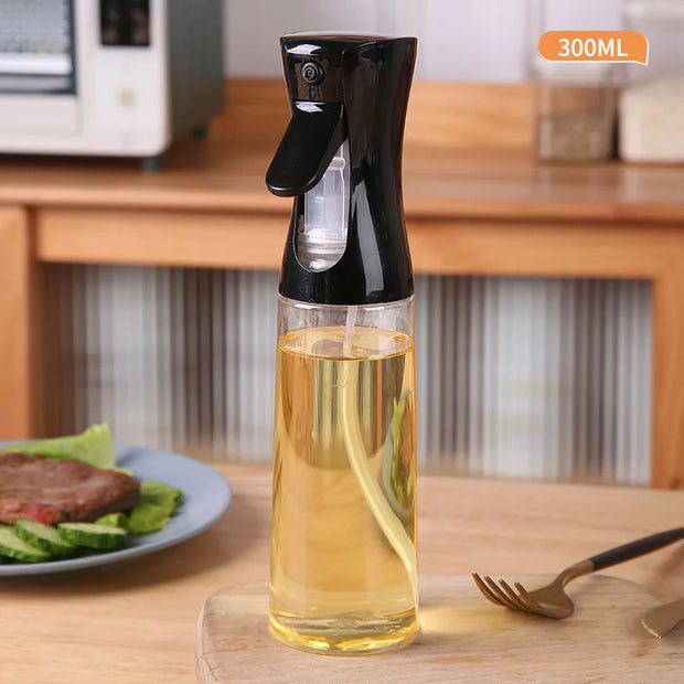 Spray bottle with oil on a kitchen counter with a plate of food in the background