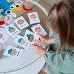 Child playing with emotion cards on a round table