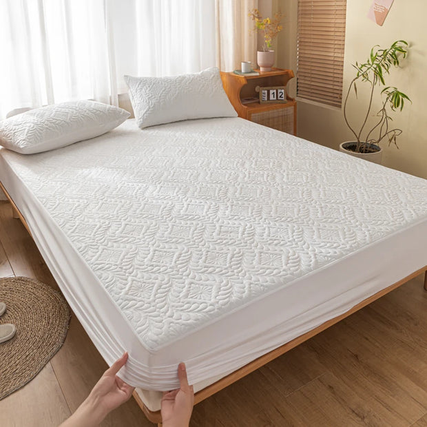White mattress cover being held by a person in a bedroom setting.