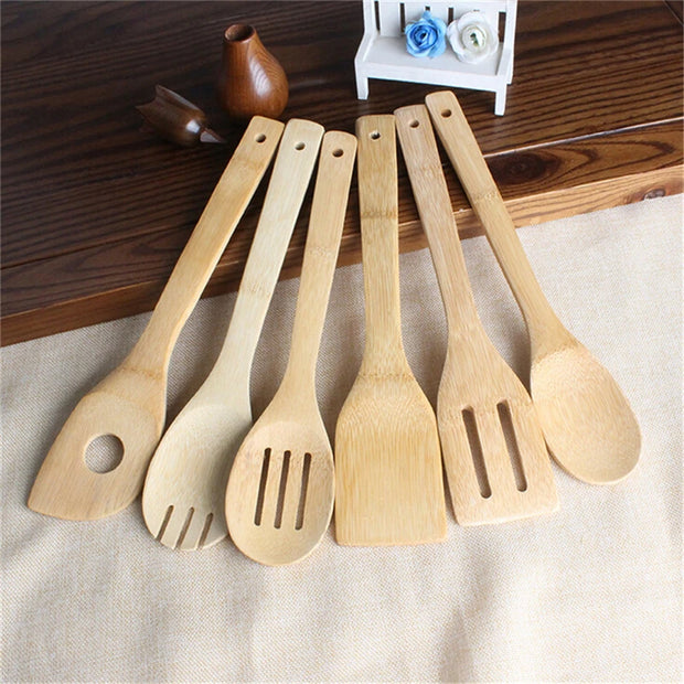 Set of wooden kitchen utensils on a wooden surface