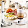 Breville coffee and espresso machine on a table with breakfast items including eggs, bacon, and a latte.