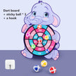 Children's dart board with elephant design, three sticky balls, and a hook on a purple background.