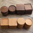 Set of wooden coasters in various shapes and sizes on a wooden surface