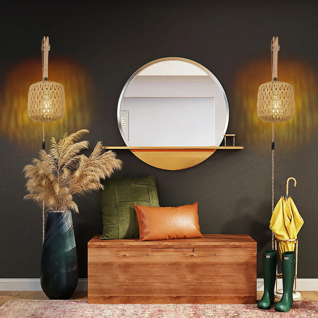 Decorative interior setting with a wooden bench, mirror, and potted plant against a dark wall.