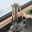 Kitchen utensil holder with 360-degree rotation feature, held by a hand in a kitchen setting.