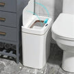 White trash can with a lid in a bathroom setting