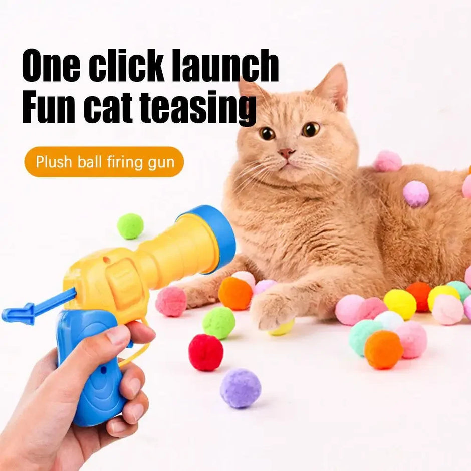 Cat playing with a plush ball firing gun on a white background