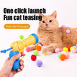 Cat playing with a plush ball firing gun on a white background