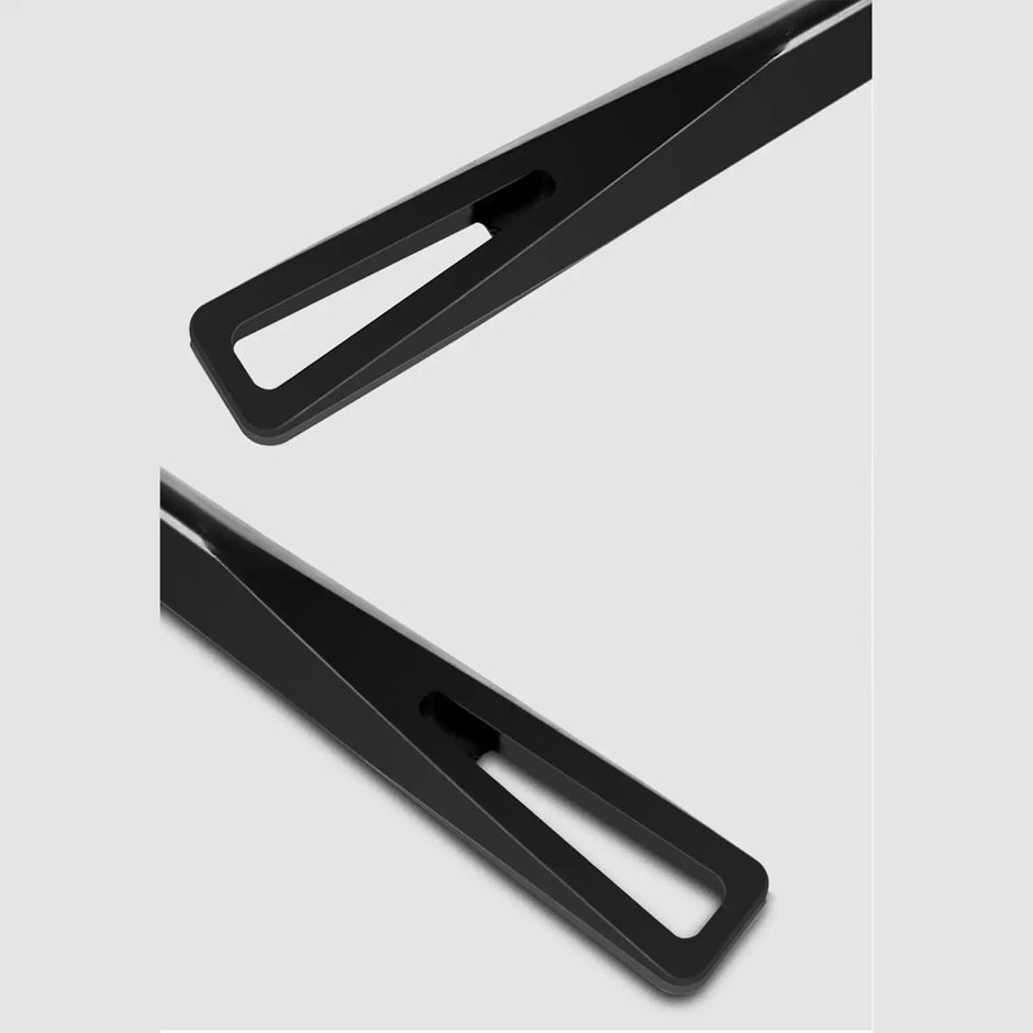 Two black hair clips on a light gray background