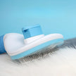 Blue and white pet grooming brush with bristles on a light blue background